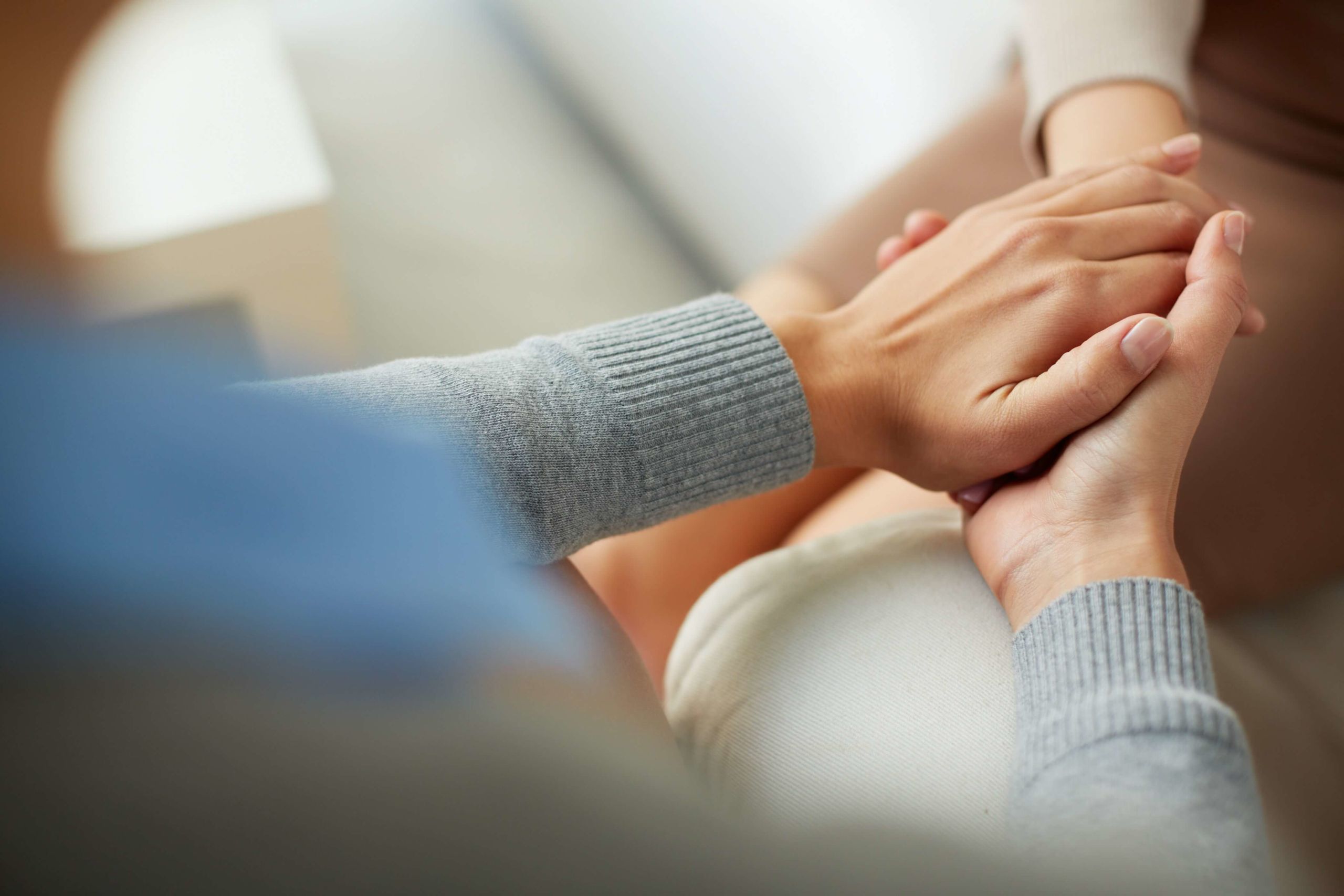 therapist holding patient's hand